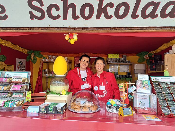 Zwei in rot gekleidete Mitarbeiterinnen beim Social Active Day lächeln in die Kamera.